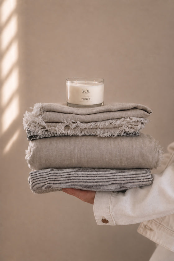 Ribbon-free natural linen stacks with a SOL Linen Tonka candle
